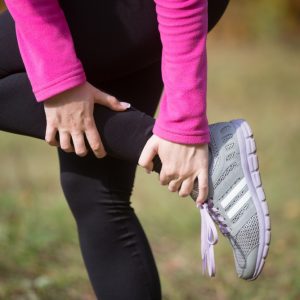 warming-up-outdoors-autumn-holding-ankle